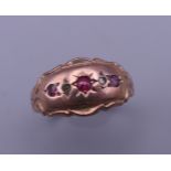 A 9 ct gold, diamond and ruby gypsy set ring. Ring size O/P. 2 grammes total weight.