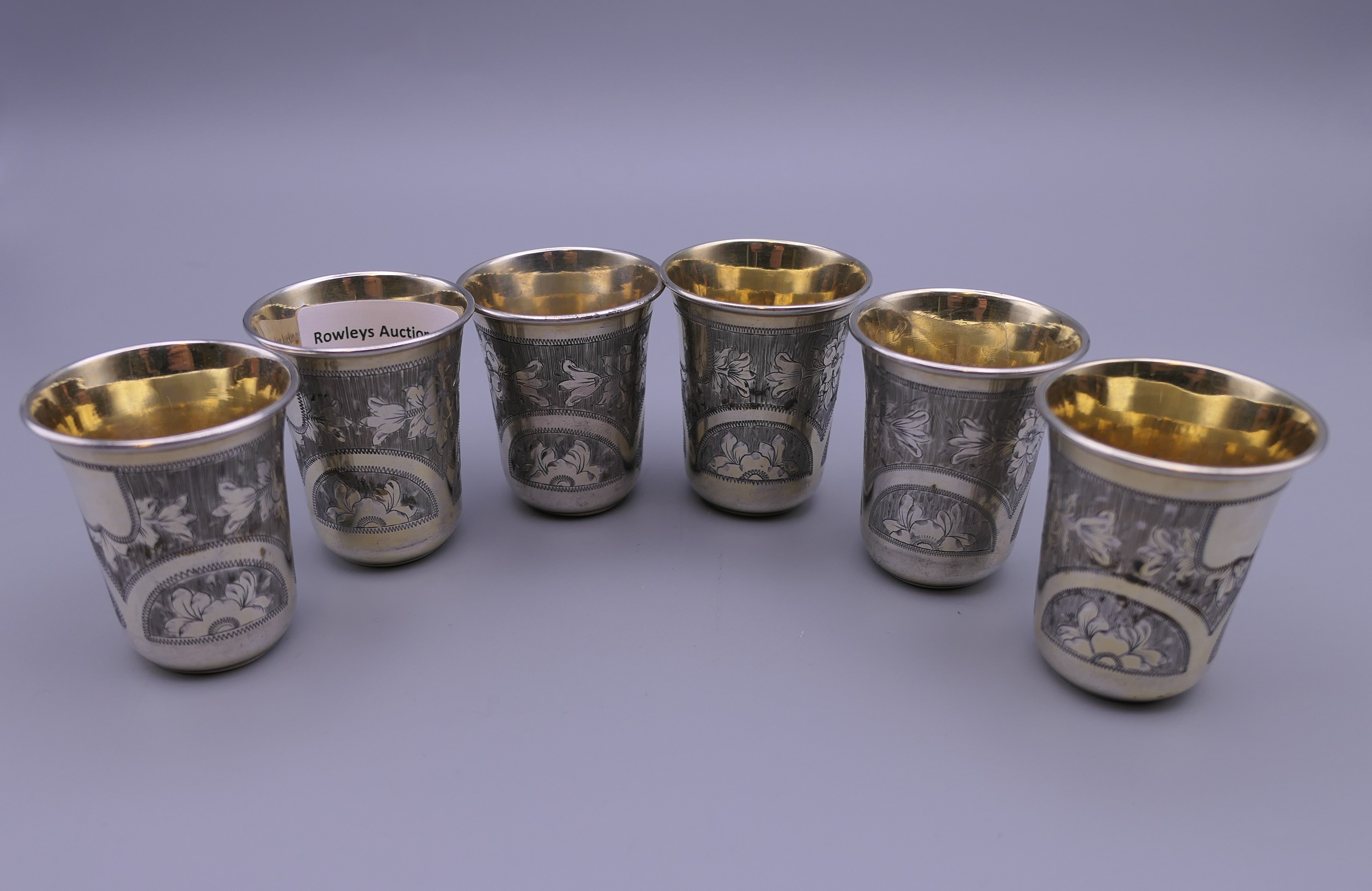 A set of six Russian silver gilt beakers. Each 5 cm high.