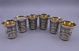 A set of six Russian silver gilt beakers. Each 5 cm high.