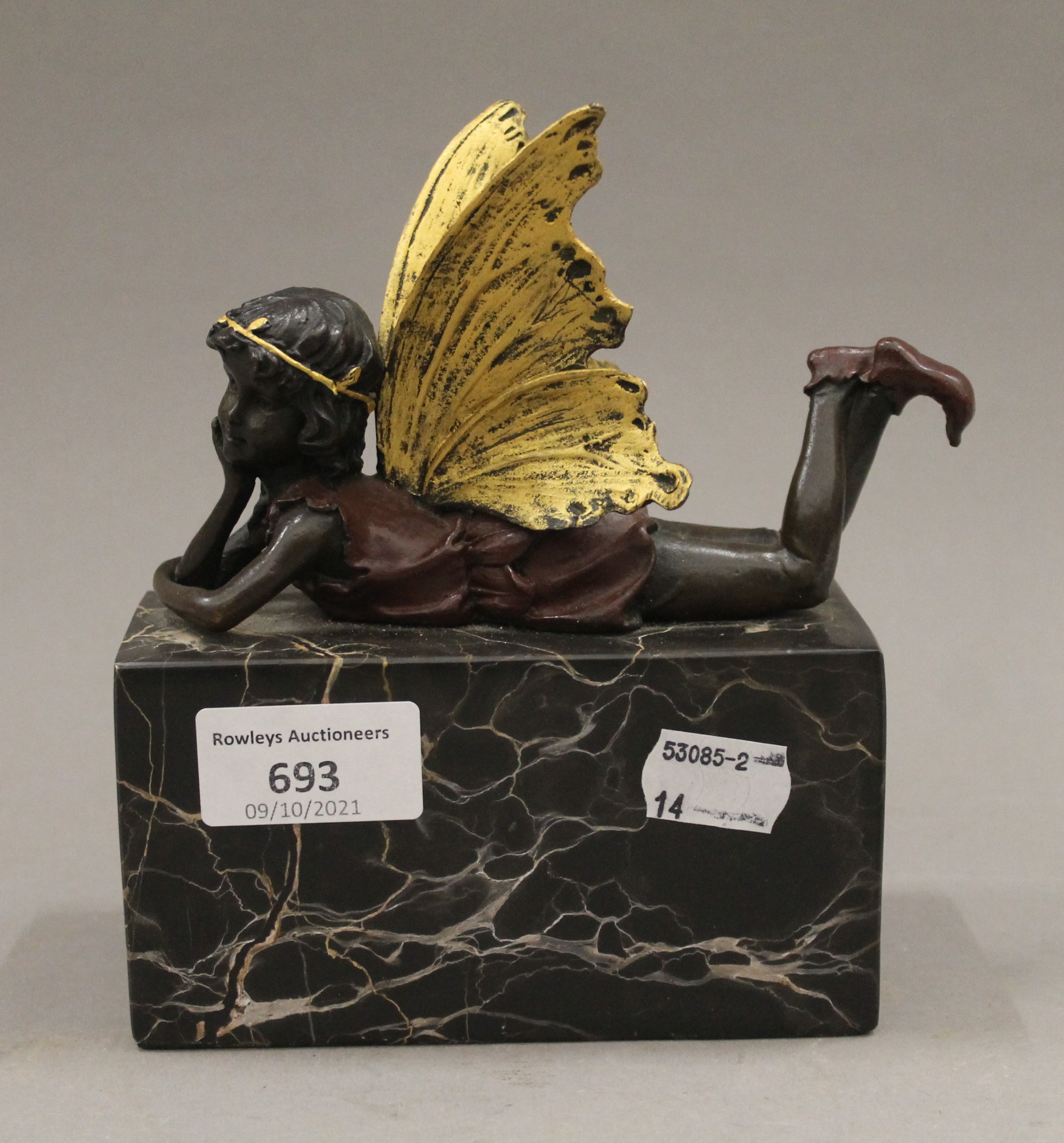 A bronze model of a pixie on a marble base. 13 cm long.