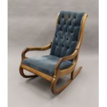 A Victorian mahogany framed button back rocking chair. 58.5 cm wide.