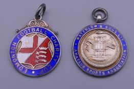Two 1930s enamel and silver fobs.