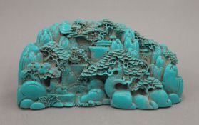 A turquoise coloured model of a Chinese mountainous scene. 21.5 cm wide.