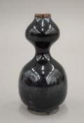 A Chinese pottery double gourd vase. 12 cm high.