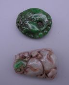 Two jade carved pendants. The largest 5.5 cm high.