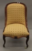 A Victorian mahogany framed spoon back nursing chair. 52 cm wide.