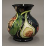 A small Moorcroft porcelain vase. 9 cm high.