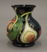 A small Moorcroft porcelain vase. 9 cm high.