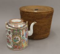 A 19th century Canton porcelain tea pot in original basket.