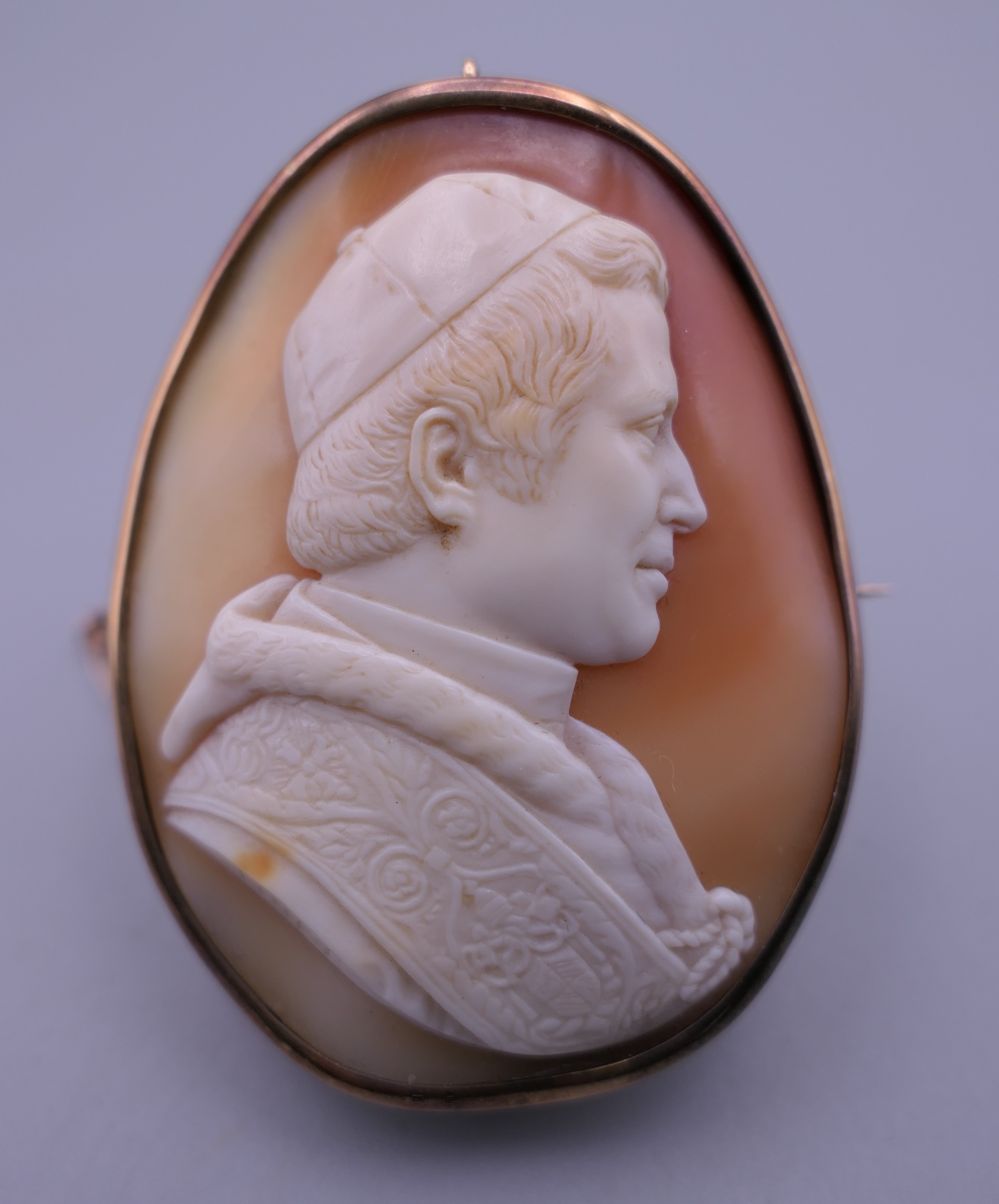A 19th century unmarked gold framed cameo brooch carved as Pope Pius IX, signed Finet. 5.5 cm high.