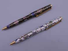 Two cloisonne pens. Each approximately 13 cm long.