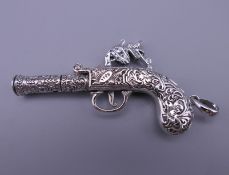 A silver pendant formed as a gun. 6 cm long. 22 grammes.