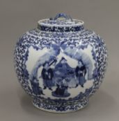 A 19th century Chinese blue and white lidded bulbous vase. 24 cm high.