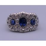 An unmarked gold, diamond and sapphire ring. Ring size O. 4.9 grammes total weight.