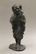 A Japanese Meiji period bronze model of a man and monkey. 32 cm high.