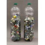 Two bottles of vintage glass marbles.