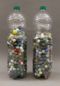 Two bottles of vintage glass marbles.