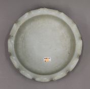 A Chinese celadon ground pottery bowl. 24 cm diameter.