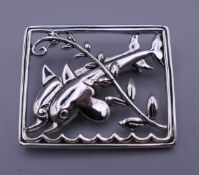 A Denmark sterling silver dolphin brooch. 4.25 cm wide.