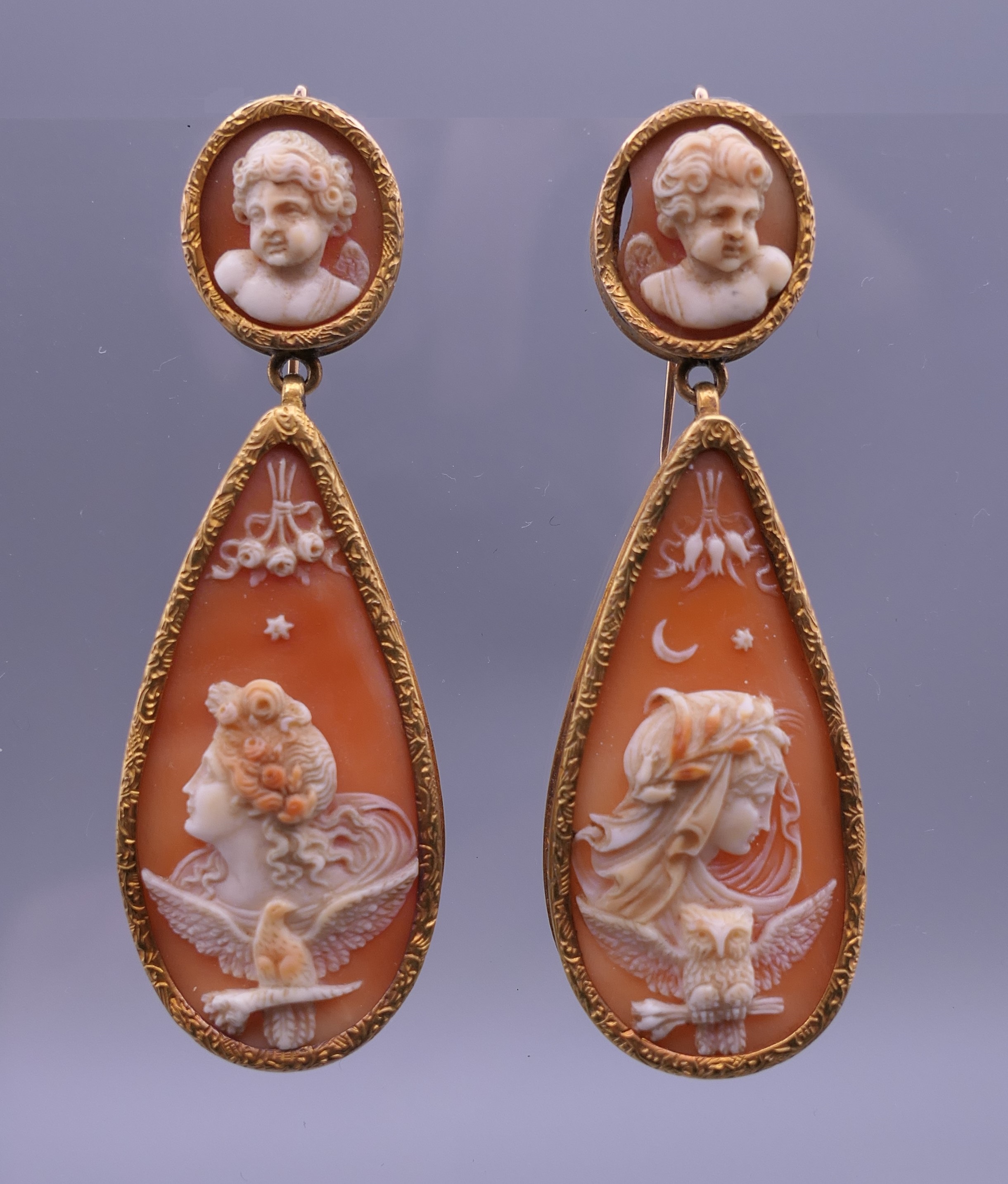 A pair of 18th/19th century unmarked gold mounted cameo drop earrings. Each 6 cm high.