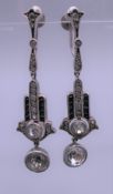 A pair of silver dress earrings. Each 4 cm high.