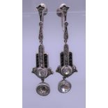 A pair of silver dress earrings. Each 4 cm high.