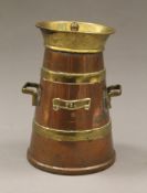 A brass and copper tea caddy formed as a milk churn. 19 cm high.
