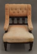 A Victorian walnut framed upholstered nursing chair. 54 cm wide.