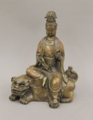 A bronze model of Guanyin on fo dog. 24.5 cm high.