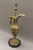 A brass table lamp of ewer form. 76 cm high.