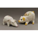 A large porcelain piggy bank and another pig. The latter 30 cm long.