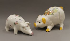 A large porcelain piggy bank and another pig. The latter 30 cm long.