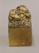 A Chinese gilt bronze seal surmounted with goats. 9.5 cm high.