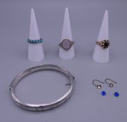 A 9 ct gold and garnet ring, two other rings, a pair of earrings and a silver bracelet.