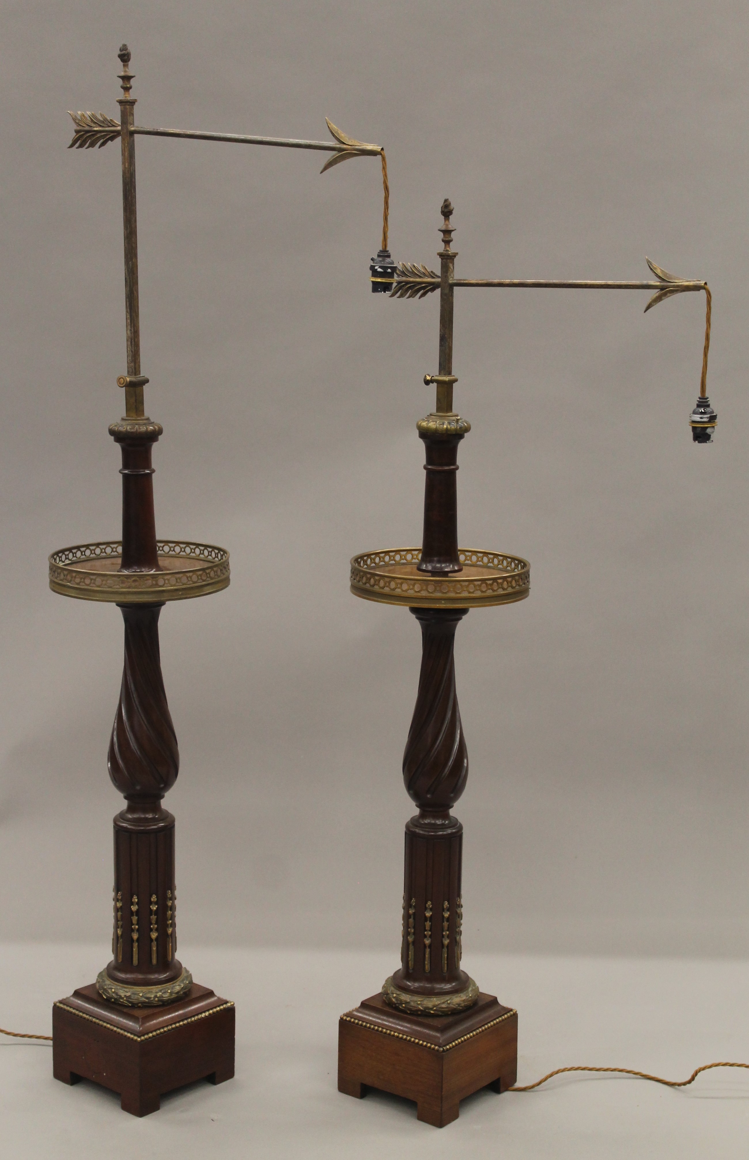 A pair of Dreyfous ormolu mounted mahogany adjustable floor standing lamps,