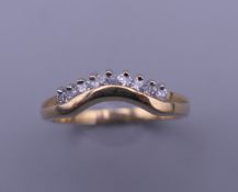 A 9 ct gold nine stone diamond wishbone ring. Ring size P/Q. 2.4 grammes total weight.