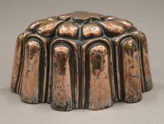 A 19th century copper jelly mould, inscribed R A Mess 1850. 19 cm long.