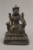 A bronze model of Buddha seated on a dog of fo. 22 cm high.