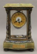 An enamel decorated onyx four glass clock. 34 cm high.