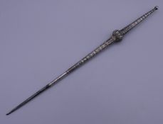 An Ottoman steel, brass and silver inlaid stiletto. 26.5 cm long.