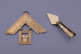 A silver gilt Masonic pendant and a Masonic tie clip. The former 5.5 cm wide.