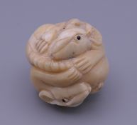 A carved bone netsuke formed as rats. 4 cm high.