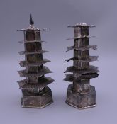 A pair of Chinese silver salt and pepper formed as pagodas. The largest 8.5 cm high. 43.7 grammes.