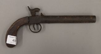 A 19th century percussion pistol. 23 cm long.