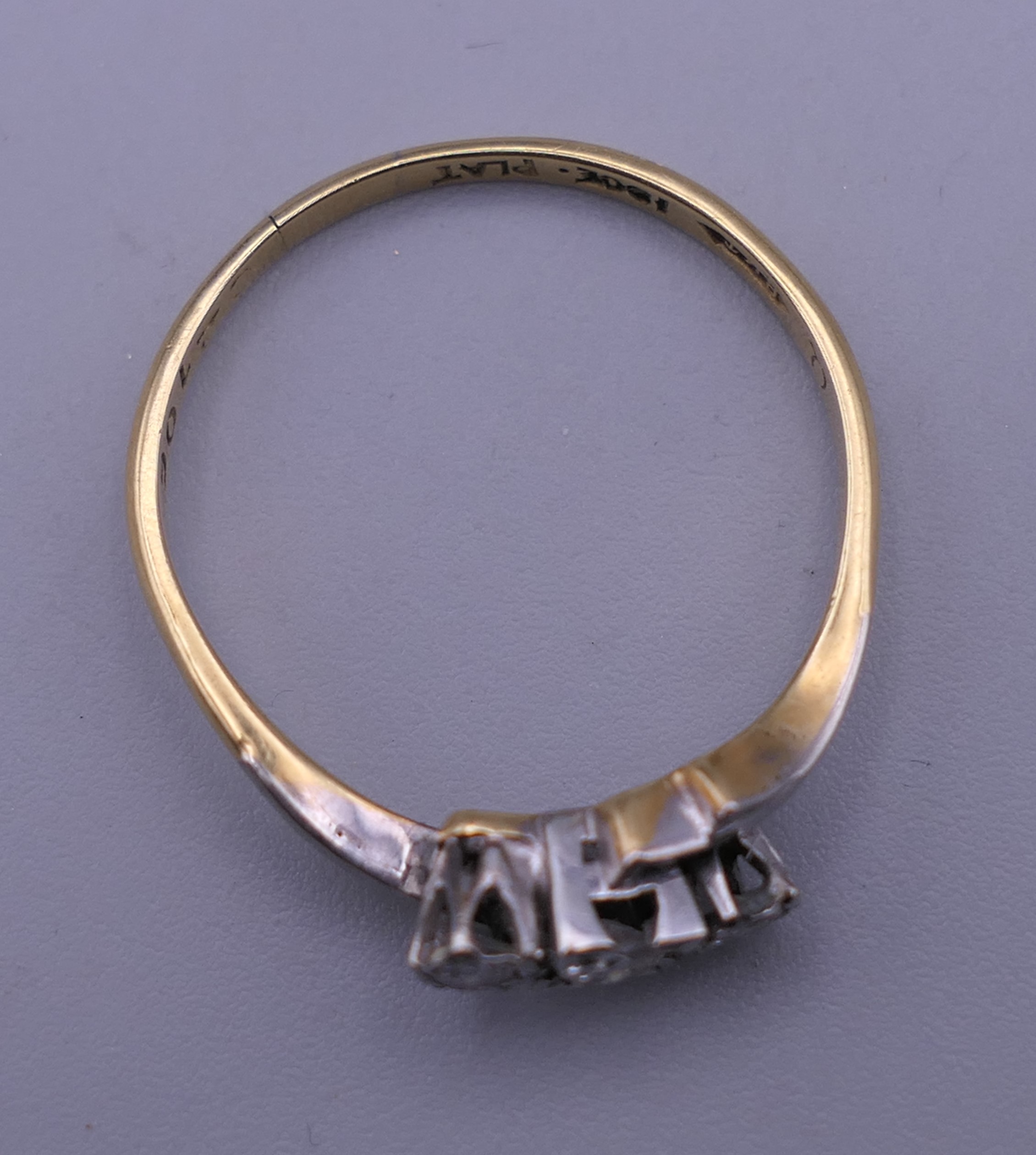 An 18 ct gold and platinum three stone diamond ring. Ring size R/S. 2.6 grammes total weight. - Image 4 of 6