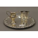 Two silver jugs and an embossed platter. The latter 29.5 cm diameter. 26.8 troy ounces.