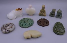 A quantity of Chinese jade carvings. The snuff bottle 6 cm high.