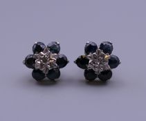 A pair of 9 ct gold, diamond and sapphire earrings. 9 mm diameter.