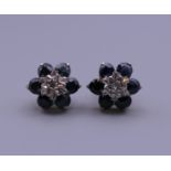 A pair of 9 ct gold, diamond and sapphire earrings. 9 mm diameter.