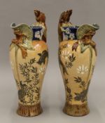 A pair of unusual Doulton Lambeth ewers. Each 34 cm high.